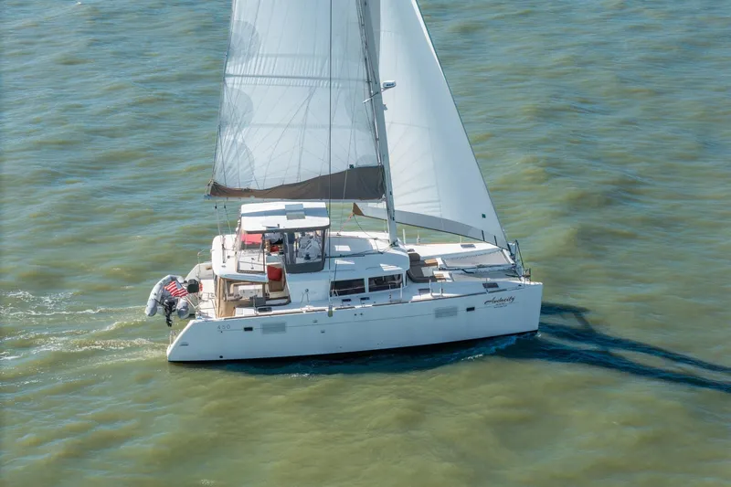 Audacity Yacht Photos Pics 2013 Lagoon 450 catamaran sailing on open water, viewed from above.