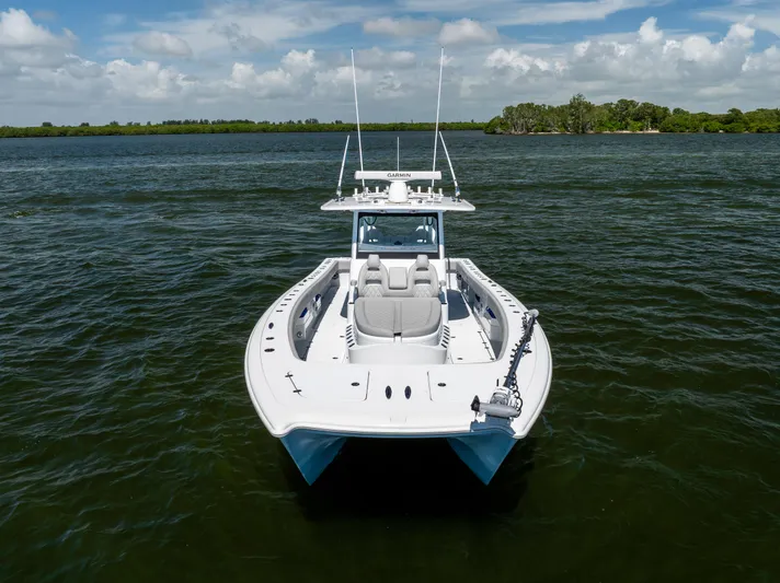  Yacht Photos Pics 2024 Freeman 35 boat on water, clear sky, lush shoreline in background.