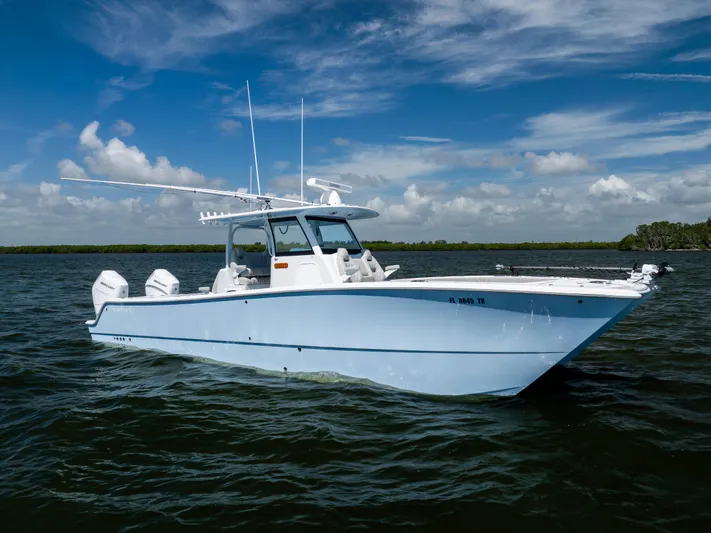  Yacht Photos Pics 2024 Freeman 35 boat on water under blue sky with clouds.