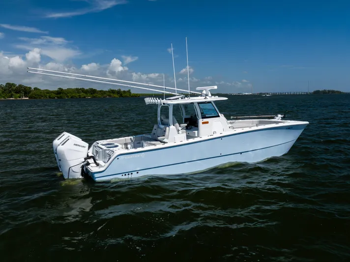  Yacht Photos Pics 2024 Freeman 35 boat on open water, featuring twin Mercury engines under a clear blue sky.