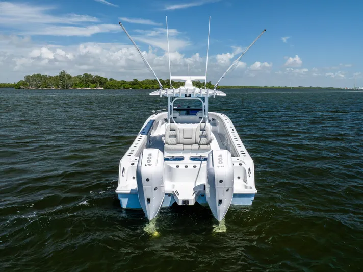  Yacht Photos Pics 2024 Freeman 35 boat on water, rear view with dual engines, clear sky.