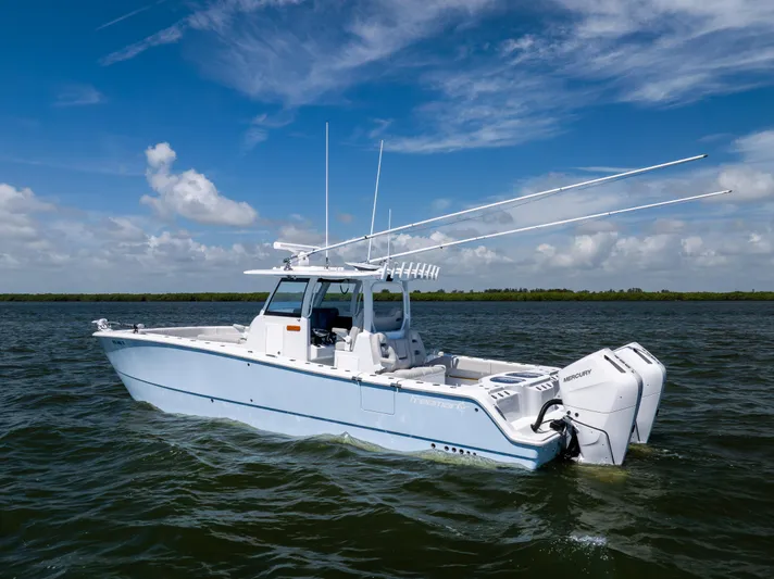  Yacht Photos Pics 2024 Freeman 35 boat on water with dual Mercury engines under a clear blue sky.