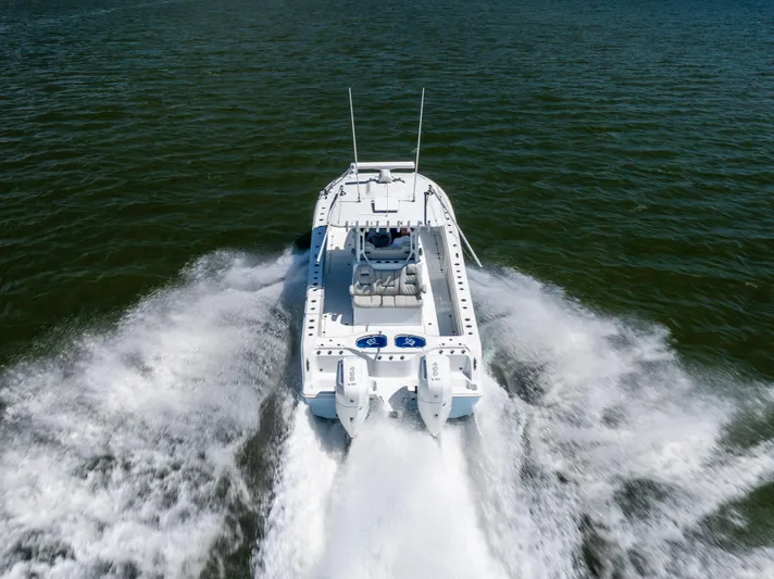  Yacht Photos Pics 2024 Freeman 35 boat cruising on open water, rear view with twin engines.