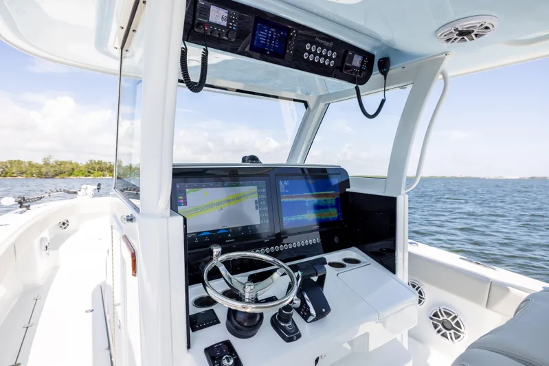  Yacht Photos Pics 2024 Freeman 35 boat cockpit with advanced navigation system and steering wheel on open water.