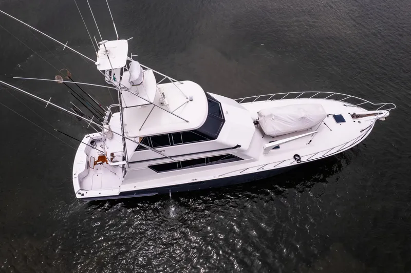 Premium Yacht Photos Pics Aerial view of a 1996 Hatteras Convertible Sportfisher yacht on calm water.