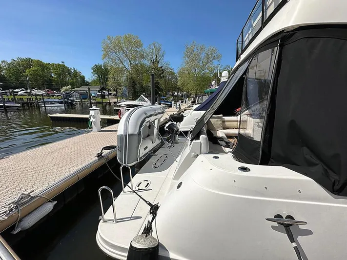  Yacht Photos Pics 2013 Sea Ray 450 Sedan Bridge yacht docked at marina, sunny day, clear blue sky.