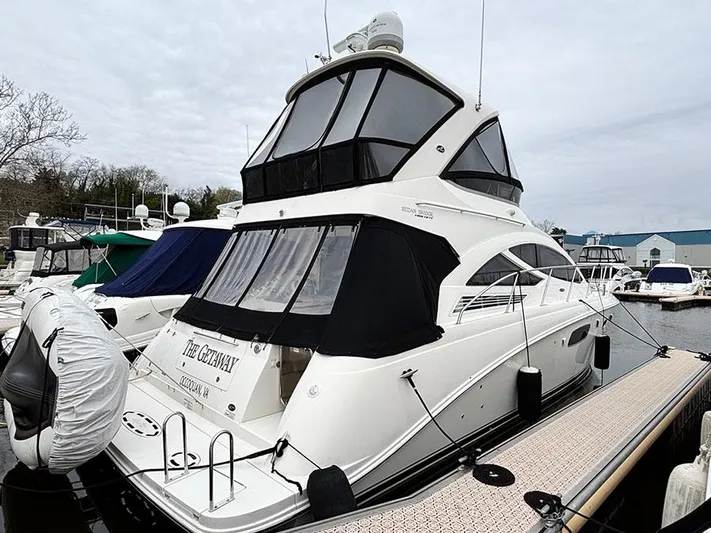  Yacht Photos Pics 2013 Sea Ray 450 Sedan Bridge yacht docked at marina, featuring sleek design and spacious upper deck.