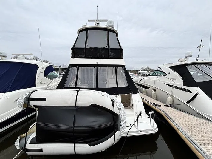  Yacht Photos Pics 2013 Sea Ray 450 Sedan Bridge yacht docked with inflatable boat attached.
