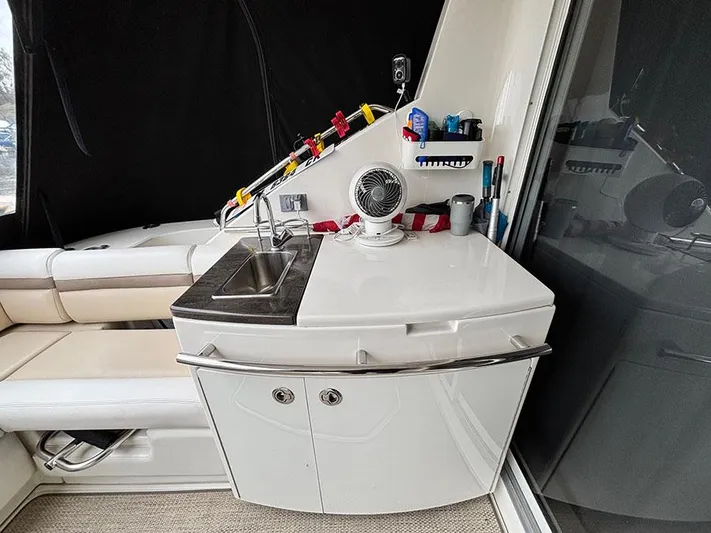  Yacht Photos Pics 2013 Sea Ray 450 Sedan Bridge interior with sink and seating area.