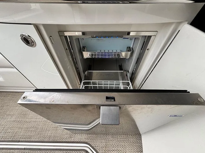  Yacht Photos Pics Open refrigerator on 2013 Sea Ray 450 Sedan Bridge yacht, showcasing interior storage space.