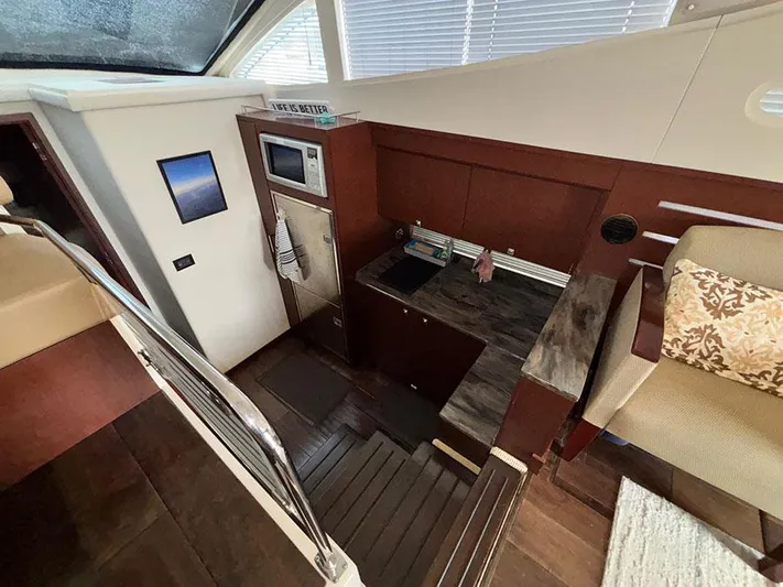  Yacht Photos Pics Interior of 2013 Sea Ray 450 Sedan Bridge yacht with modern kitchen and seating area.