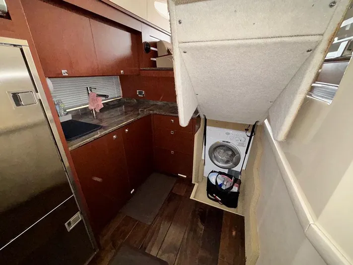  Yacht Photos Pics 2013 Sea Ray 450 Sedan Bridge interior with kitchen and washing machine.