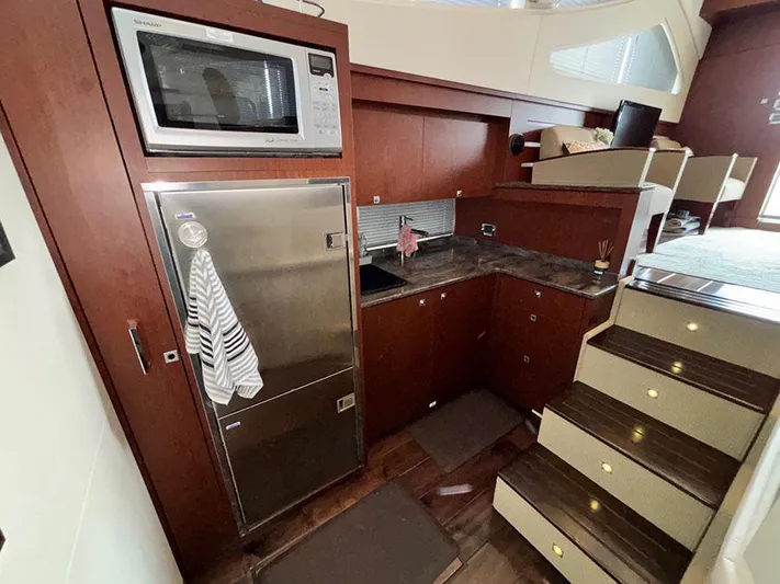  Yacht Photos Pics Interior of 2013 Sea Ray 450 Sedan Bridge yacht with kitchen and stairs.
