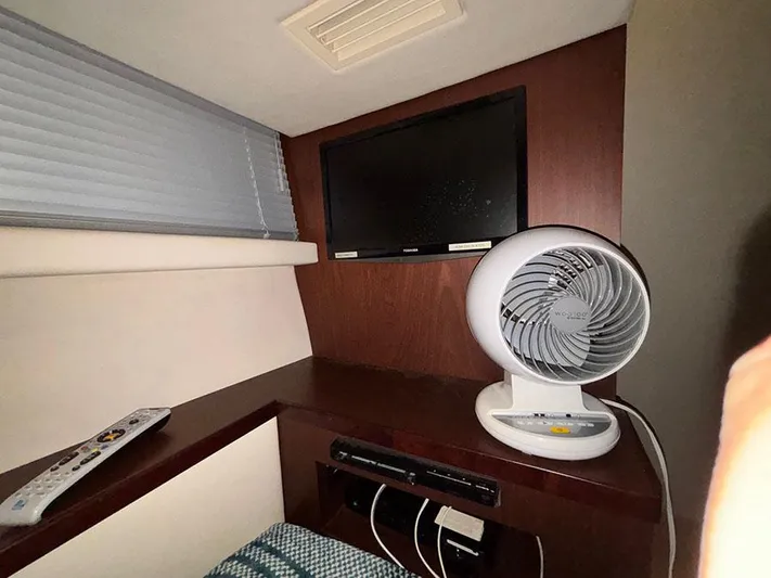  Yacht Photos Pics Interior of 2013 Sea Ray 450 Sedan Bridge with TV, fan, and remote control.