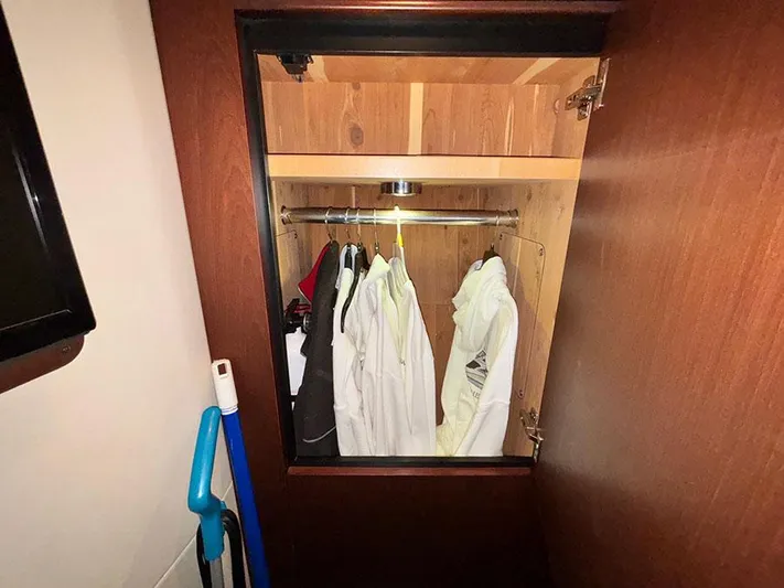  Yacht Photos Pics Closet interior on 2013 Sea Ray 450 Sedan Bridge with hanging clothes and cleaning tools.