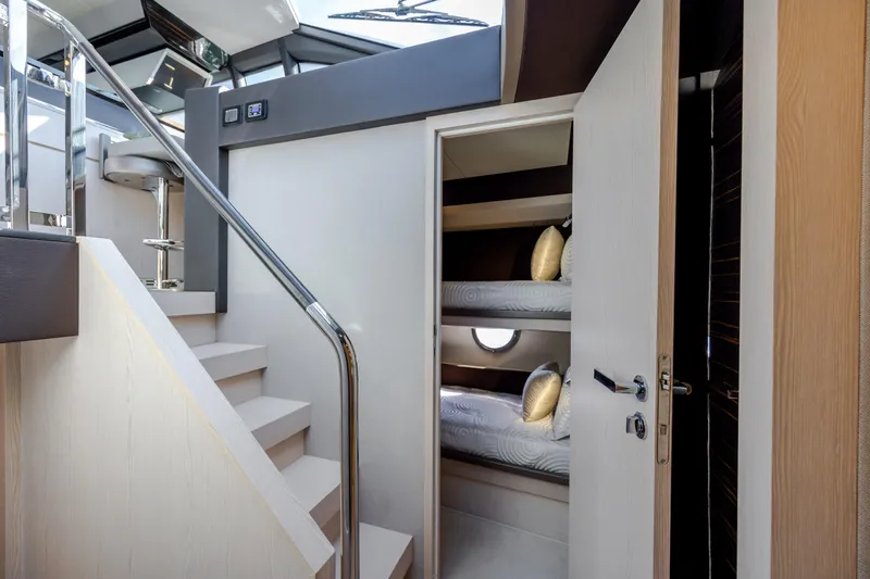  Yacht Photos Pics 2019 Azimut 66 Flybridge interior with bunk beds and modern staircase design.