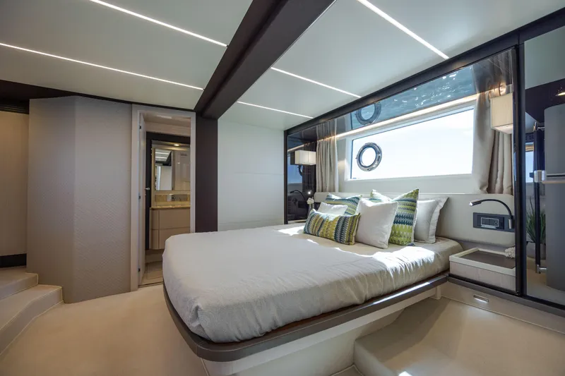  Yacht Photos Pics Luxurious bedroom interior of 2019 Azimut 66 Flybridge yacht with modern design and natural light.