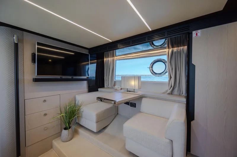  Yacht Photos Pics Luxurious interior of 2019 Azimut 66 Flybridge yacht with modern seating and large window.