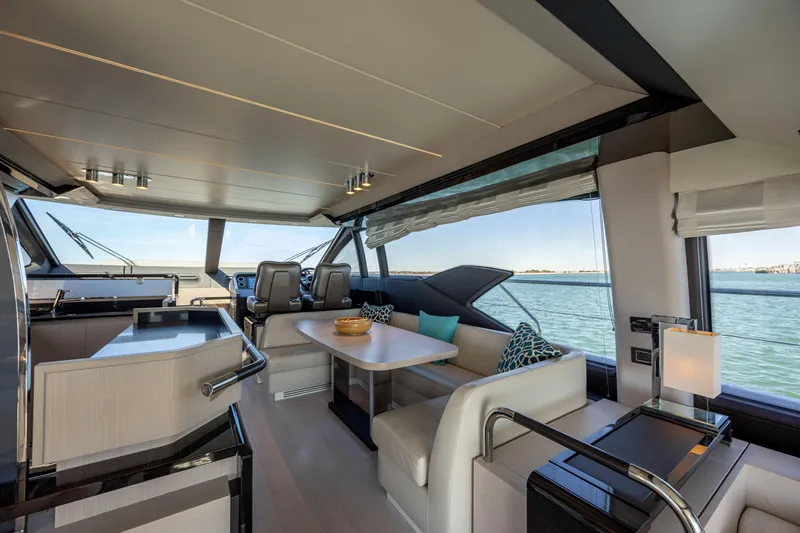  Yacht Photos Pics Luxurious interior of 2019 Azimut 66 Flybridge yacht with elegant seating and ocean view.