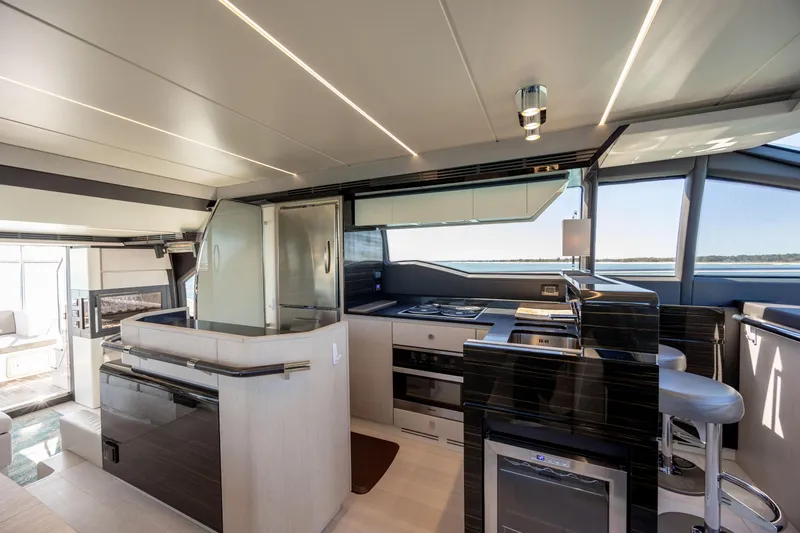  Yacht Photos Pics Luxurious interior of 2019 Azimut 66 Flybridge yacht, featuring modern kitchen and seating area.
