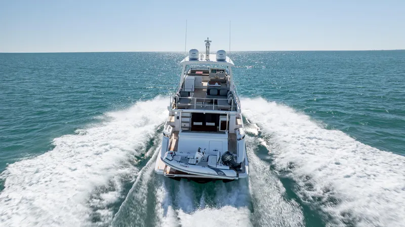  Yacht Photos Pics Azimut 66 Flybridge 2019 yacht cruising on open sea, rear view.