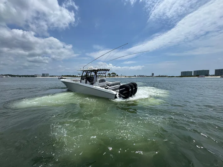  Yacht Photos Pics 2021 Fountain 38TE boat cruising on open water under a partly cloudy sky.
