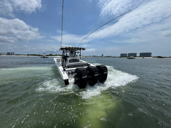  Yacht Photos Pics Fountain 38TE boat cruising on water, featuring triple 400 horsepower engines, 2021 model.