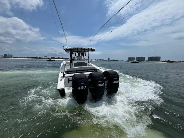  Yacht Photos Pics 2021 Fountain 38TE boat with triple 400 horsepower engines cruising on open water.