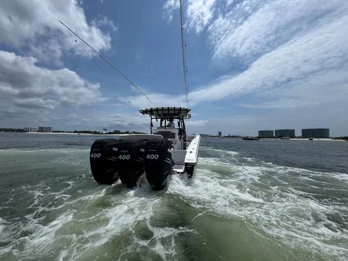  Yacht Photos Pics 2021 Fountain 38TE boat with triple 400 engines cruising on open water.