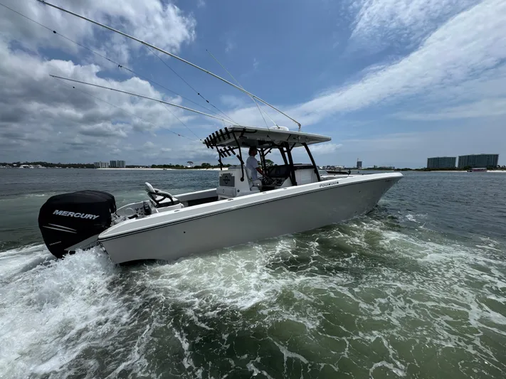  Yacht Photos Pics 2021 Fountain 38TE boat cruising on water with Mercury engine, under a partly cloudy sky.
