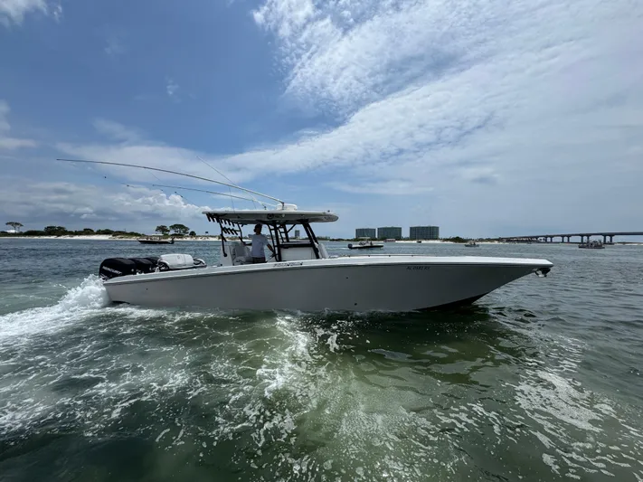  Yacht Photos Pics 2021 Fountain 38TE boat cruising on open water under a partly cloudy sky.