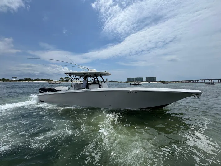  Yacht Photos Pics 2021 Fountain 38TE boat cruising on open water under a partly cloudy sky.