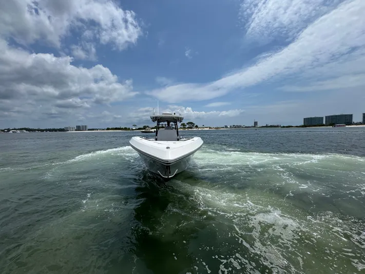  Yacht Photos Pics 2021 Fountain 38TE boat cruising on open water under a partly cloudy sky.
