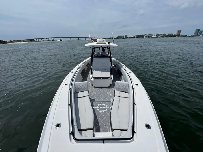  Yacht Photos Pics 2021 Fountain 38TE boat cruising on water with bridge and cityscape in background.