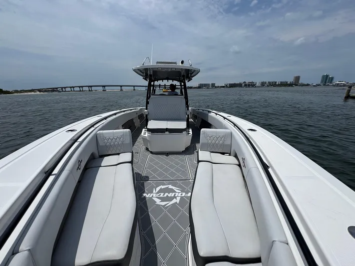  Yacht Photos Pics 2021 Fountain 38TE boat on water, featuring spacious seating and sleek design.