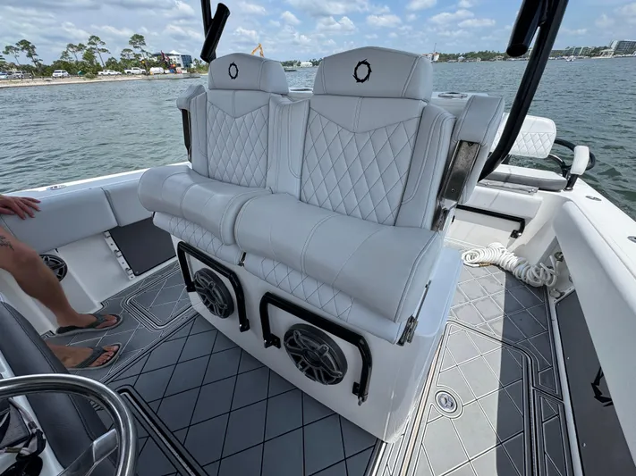  Yacht Photos Pics Luxury seating on a 2021 Fountain 38TE boat, featuring diamond-stitched upholstery and marine speakers.