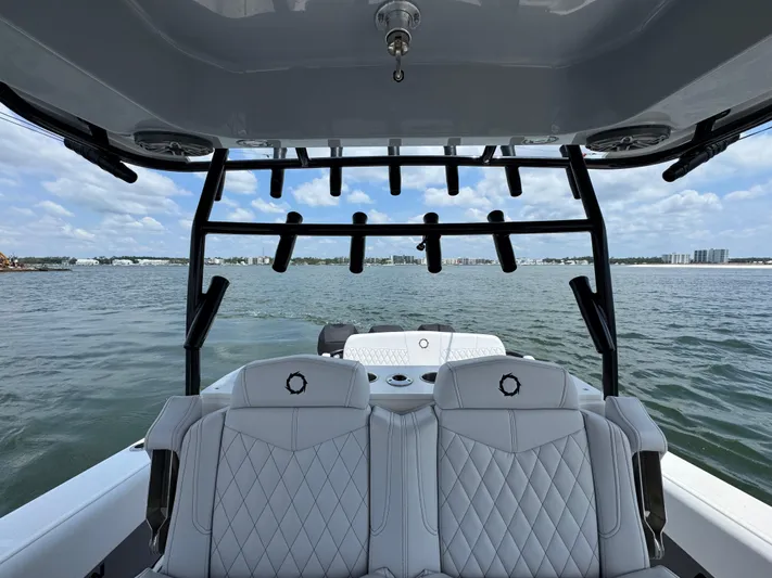  Yacht Photos Pics Fountain 38TE 2021 boat interior with seating, overlooking calm waters and distant shoreline.