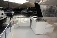 2018 Leopard 43 Powercat yacht docked at a marina with scenic mountain views.