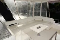 2018 Leopard 43 Powercat yacht with spacious outdoor seating area and table.