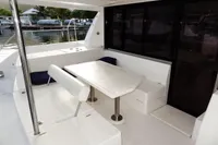2018 Leopard 43 Powercat outdoor seating area with table and bench.