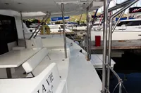 2018 Leopard 43 Powercat yacht docked at marina, featuring spacious deck and seating area.