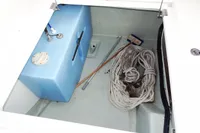 Storage compartment of a 2018 Leopard 43 Powercat with ropes and a blue tank.