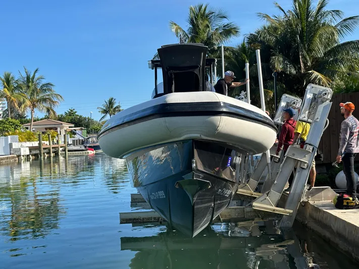  Yacht Photos Pics 2020 Technohull SEADNA 999 G5 ST boat being launched in a tropical canal setting.