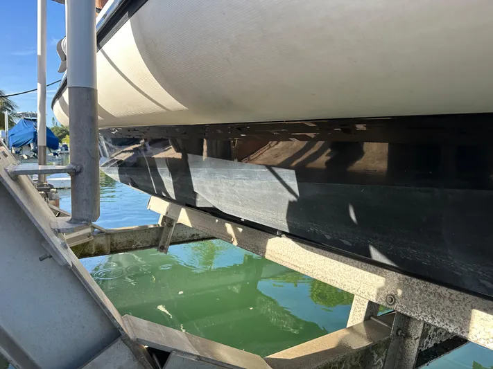  Yacht Photos Pics 2020 Technohull SEADNA 999 G5 ST boat on lift, partially submerged in water.
