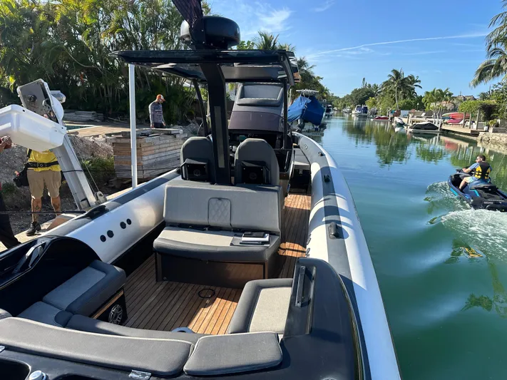  Yacht Photos Pics 2020 Technohull SEADNA 999 G5 ST boat on a sunny canal, featuring sleek seating.