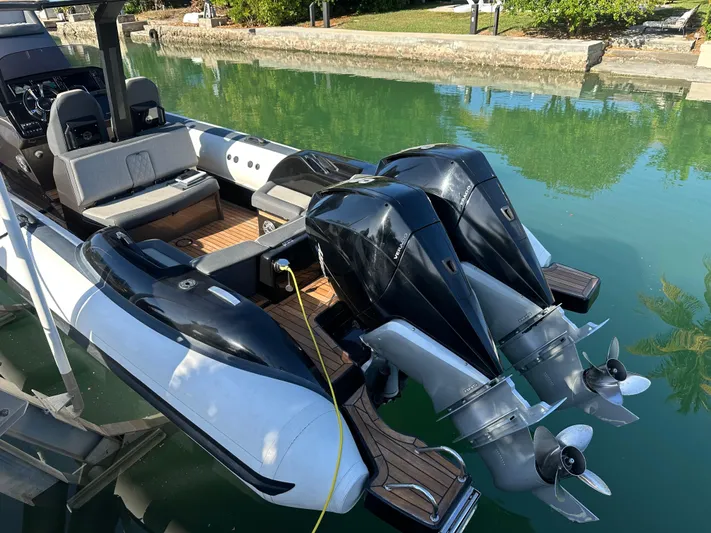  Yacht Photos Pics 2020 Technohull SEADNA 999 G5 ST boat with dual outboard engines docked in clear water.