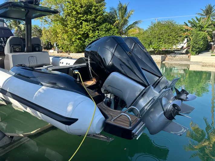  Yacht Photos Pics 2020 Technohull SEADNA 999 G5 ST boat with powerful outboard engines docked by lush greenery.