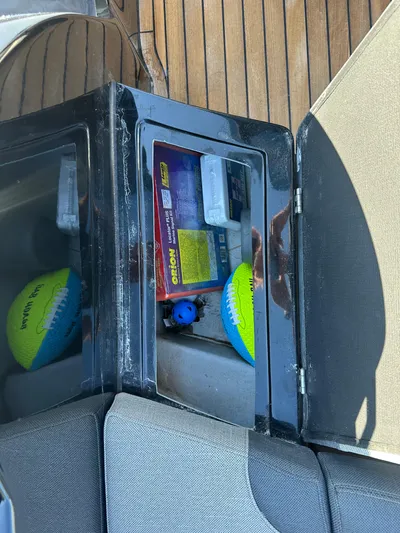  Yacht Photos Pics Storage compartment on a 2020 Technohull SEADNA 999 G5 ST with safety gear and a toy ball.