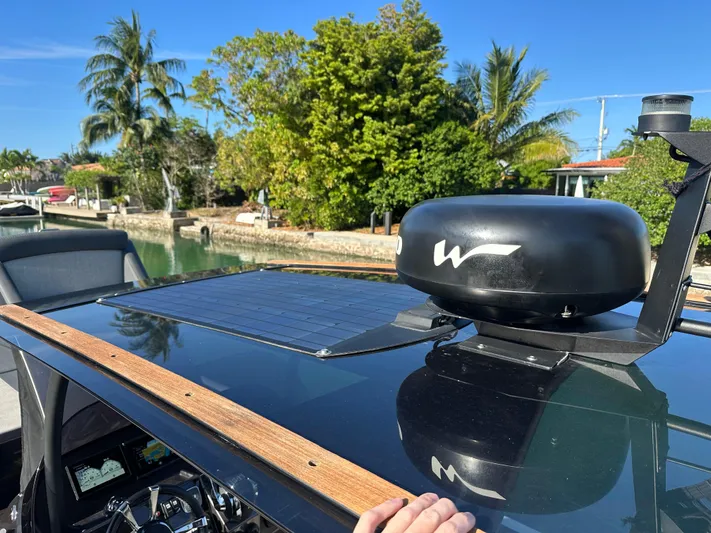  Yacht Photos Pics Technohull SEADNA 999 G5 ST 2020 boat with solar panel and radar, docked near tropical trees.