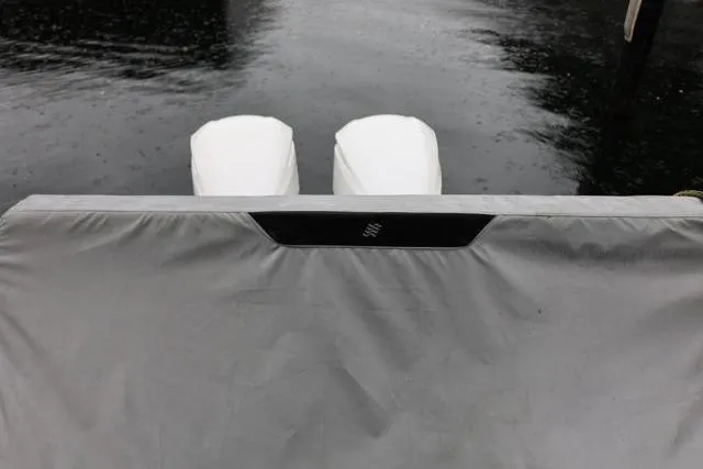  Yacht Photos Pics 2021 Four Winns V355 Coupe boat with covered engines on a calm water surface.